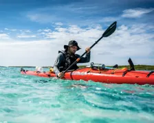Gary paddling through turquoise water