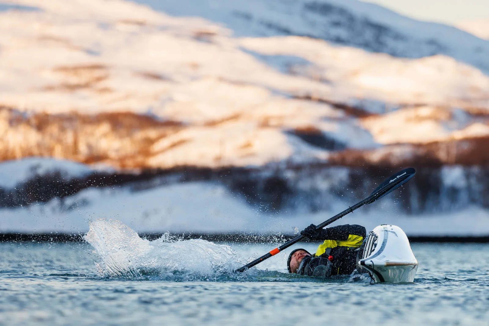 Practising a kayak roll in Arctic water
