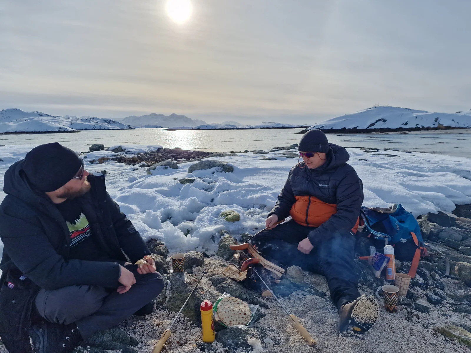 Cooking outdoors on a snow-covered Arctic shore