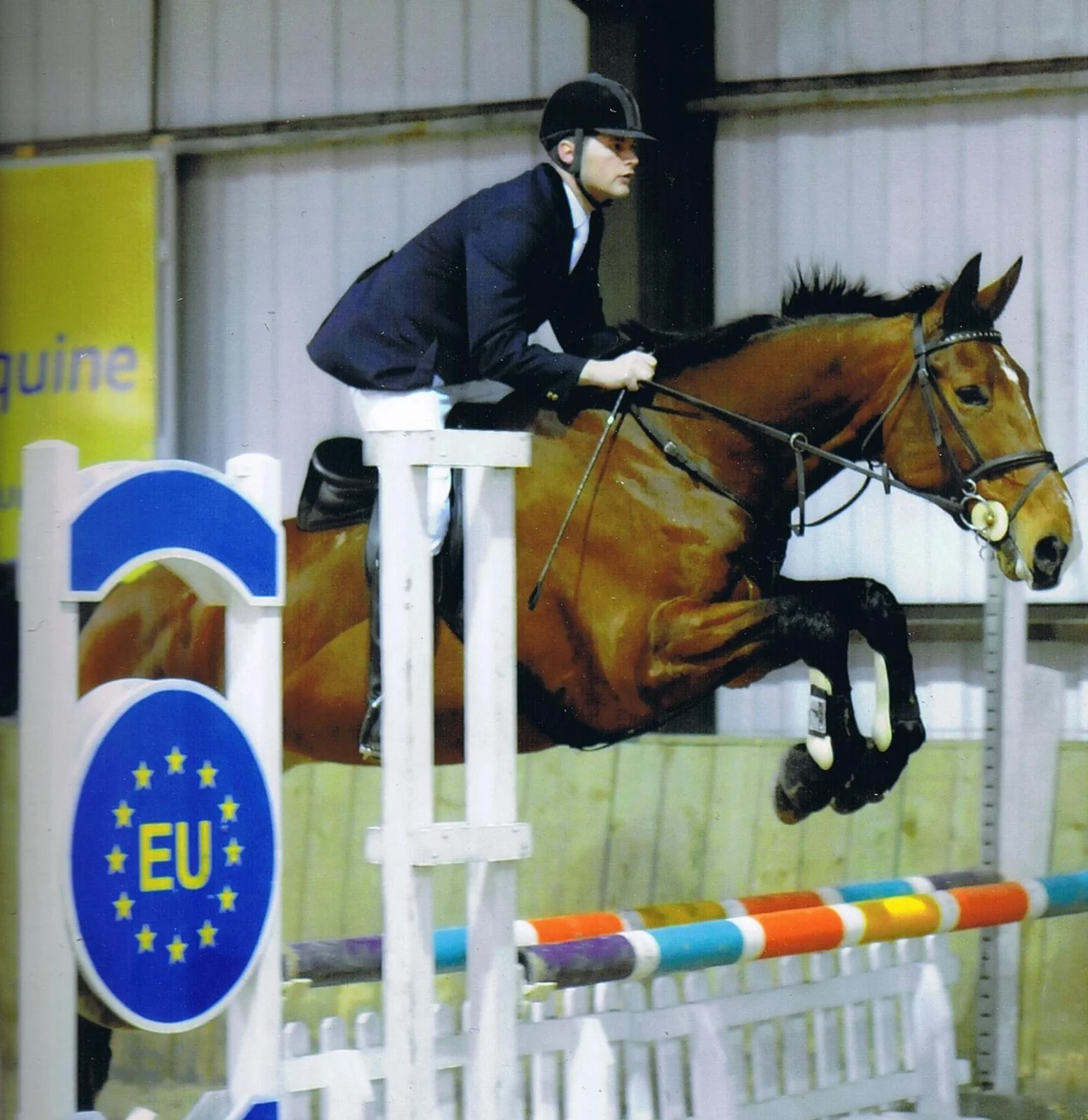 Gary riding a horse over a showjump